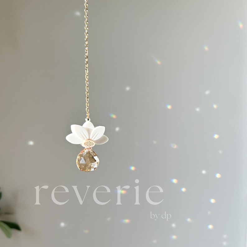 Reverie by DP gold-tone white lotus crystal car charm